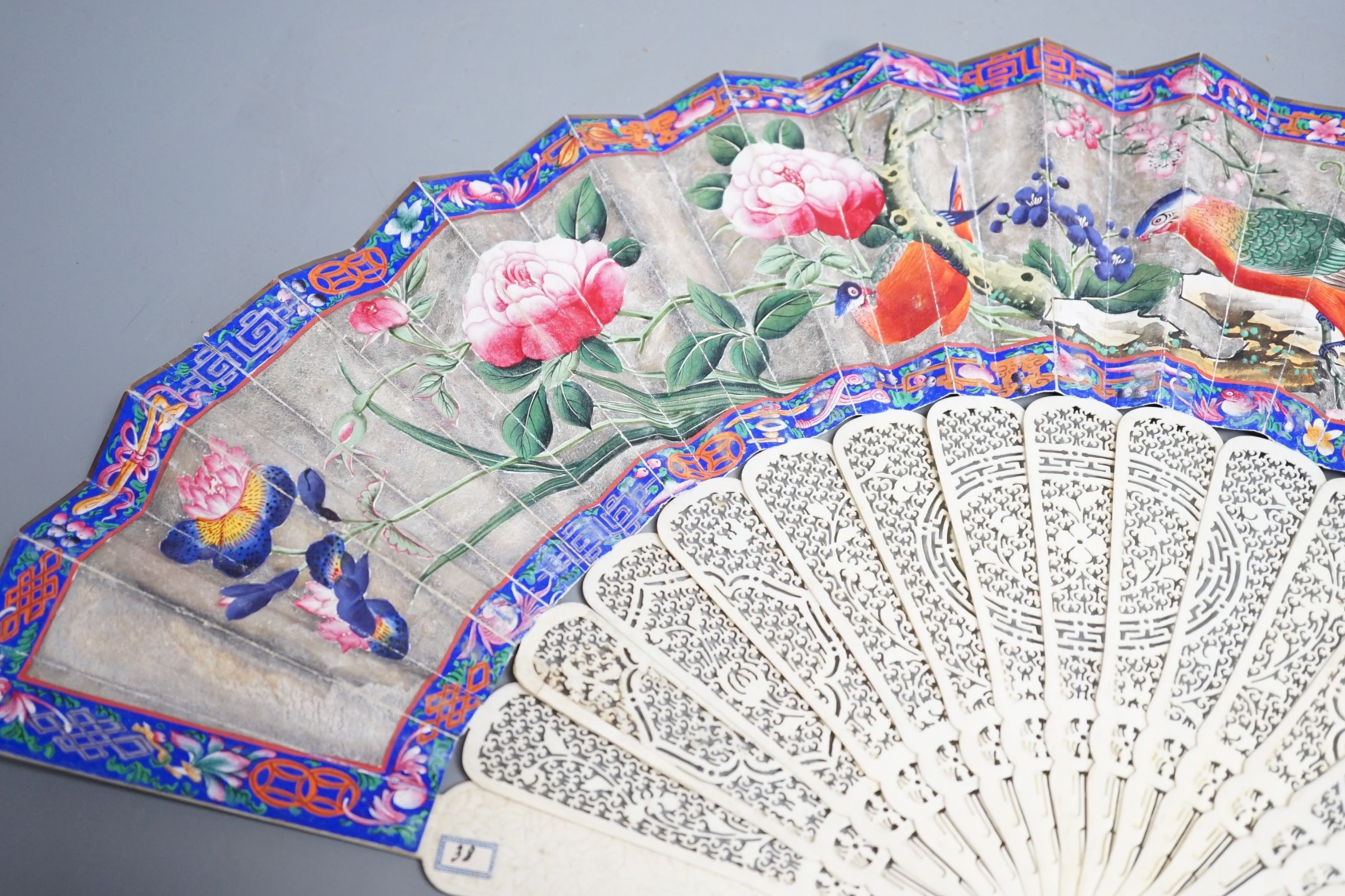 A 19th century Chinese export pierced ivory and painted paper leaf fan. 28cm long